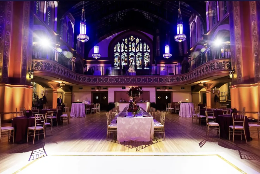 Interior of Majestic Hall wedding venue in Cleveland, Ohio with stained glass windows and chandeliers